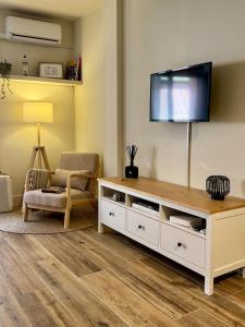 a living room with a flat screen tv on a wall at Max in Tossa de Mar