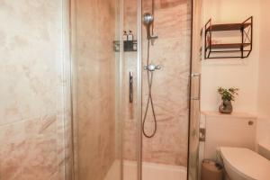 a shower with a glass door in a bathroom at Stones Throw in St Austell +20 photos