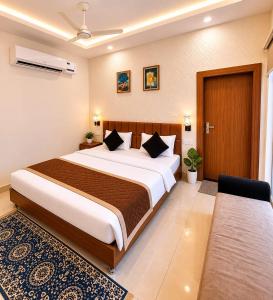 a bedroom with a large bed in a room at Megh hotel in Gangānagar
