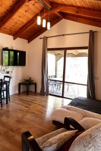 a bedroom with a bed and a balcony with a table at Orr Halevana in Bruchim Qela' Alon