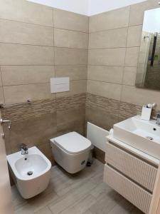 a bathroom with a toilet and a sink at La Stella dei Venti in Scilla +15 photos