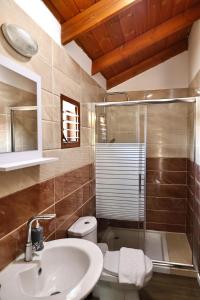 a bathroom with a sink and a shower and a toilet at Orr Halevana in Bruchim Qela' Alon +28 photos