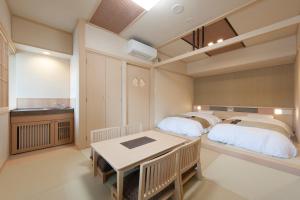 a bedroom with two beds and a table in it at Onyado Nono Sakaiminato Natural Hot Spring in Sakaiminato +66 photos