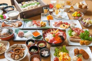 a table full of different types of food on plates at Onyado Nono Sakaiminato Natural Hot Spring in Sakaiminato
