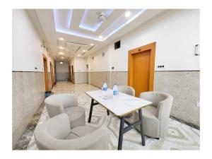 a meeting room with a table and chairs at निर्मला पैलेस अयोध्या राम मंदिर - Hotel The New Nirmala Palace Ayodhya Near-Ram-Janmabhoomi-and-Ayodhya-Ram-Mandir-with-parking-and-Restaurant-Facilities - Best Hotel In Ayodhya in Ayodhya +10 photos