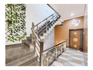 a set of stairs in a building with a door at निर्मला पैलेस अयोध्या राम मंदिर - Hotel The New Nirmala Palace Ayodhya Near-Ram-Janmabhoomi-and-Ayodhya-Ram-Mandir-with-parking-and-Restaurant-Facilities - Best Hotel In Ayodhya in Ayodhya
