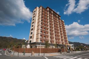 a tall building on the corner of a street at Onyado Nono Sakaiminato Natural Hot Spring in Sakaiminato