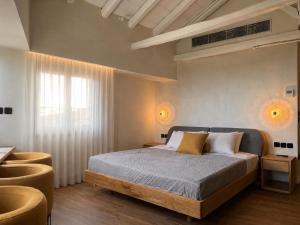 a bedroom with a bed and a table and chairs at TERPOU StoneHouse & Suites in Volos