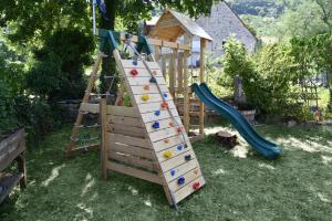 a playground with a climbing ladder and a slide at Gite Le Douglas, Vignoble et Reculées du Jura - Avec Sauna in Lavigny