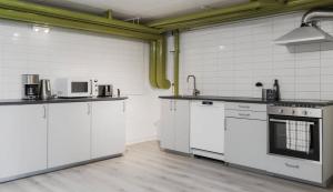 a kitchen with white counters and white appliances at Villan Lyan in Lund