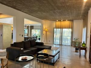 a living room with a couch and a table at Casa Benito - Barrio Privado con Piscina en Chapadmalal in Mar del Plata