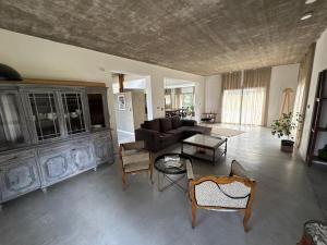 a living room with a couch and a table at Casa Benito - Barrio Privado con Piscina en Chapadmalal in Mar del Plata
