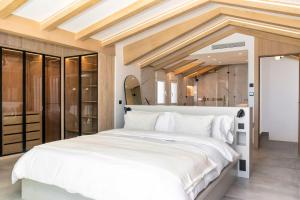 a bedroom with a large white bed in a room at Puerto Banus Duplex Lux Selection in Marbella
