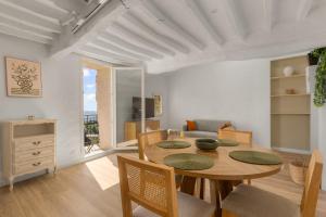 a dining room with a table and chairs and a living room at apt hospital in Tourrettes-sur-Loup