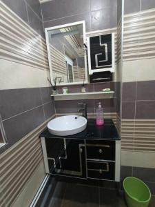 a bathroom with a sink and a mirror at Villa skikda in Skikda