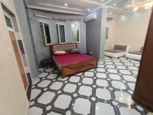 a small room with a bed and a couch in it at Villa skikda in Skikda