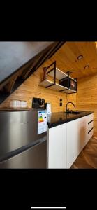 a kitchen with a sink and a stove top oven at Барнхаус in Bosteri