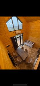 a room with a table and chairs in a wooden building at Барнхаус in Bosteri