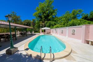 a swimming pool in the middle of a patio at Villa dei Papi Subiaco in Subiaco