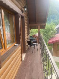 a balcony of a house with a table and chairs at TaVa House 2 in Yaremche
