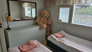 a teddy bear sitting on a ledge in a bedroom at Savonlinnan keskusta in Savonlinna +5 photos