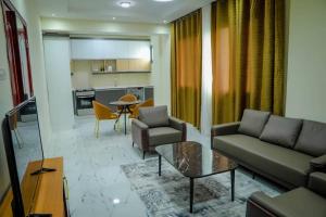 a living room with a couch and a table at Star home Tower in Mogadishu +17 photos
