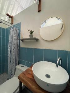 a bathroom with a sink and a mirror on the wall at Quinta Las Hortensias in Monte San Juan