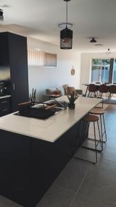 a kitchen and living room with a large counter top at Maitland Getaway - Spa, EV Friendly, Pet Friendly in Telarah