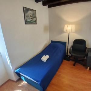 a bedroom with a blue bed and a chair at Original Mediterranean house in Vodnjan +17 photos