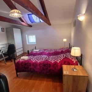 a bedroom with a bed with a red bedspread at Original Mediterranean house in Vodnjan