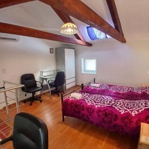 a bedroom with a bed and a desk and chairs at Original Mediterranean house in Vodnjan