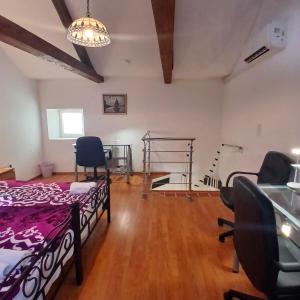 a room with a bed and chairs in it at Original Mediterranean house in Vodnjan