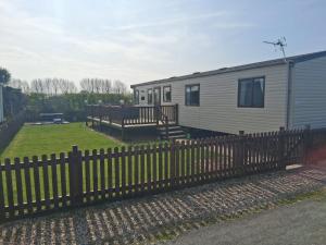 a tiny house with a fence and a yard at A21 Unity Beach, Brean in Brean