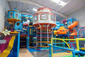 a playground with a bunch of different types of play equipment at A21 Unity Beach, Brean in Brean
