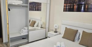 a bedroom with a white bed and a mirror at Sun Sea 3 sea view in Shkorpilovtsi +34 photos