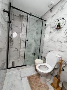 a bathroom with a toilet and a shower at Nakhla in Dar Bouazza +12 photos