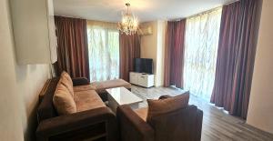 a living room with a couch and two chairs and a tv at Sun Sea 3 sea view in Shkorpilovtsi