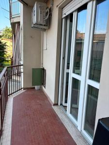 a balcony of a building with a heater and windows at Nicole's House in Asti
