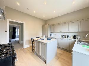 a kitchen with white cabinets and a counter top at Shellharbour in Seaview