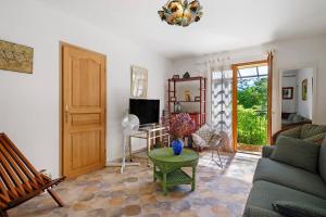a living room with a couch and a table at La Lufrerie in Sospel