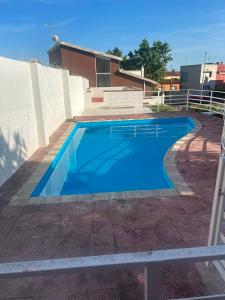 a large blue swimming pool in a yard at Miramar Viladecans in Viladecáns