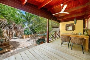 a patio with a table and chairs on a deck at Bamboo Bonaire by Boutique Bonaire Unique Resorts in Kralendijk