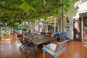 a wooden table and chairs on a patio at La Lufrerie in Sospel