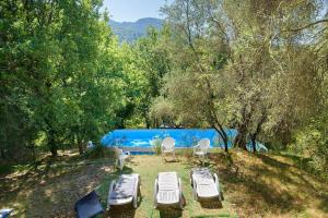 a group of chairs and lounge chairs in a yard at La Lufrerie in Sospel