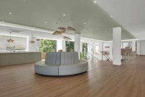 a white living room with a white couch in the middle at Hotel Palia Las Palomas in Torremolinos +57 photos
