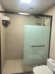a shower with a glass door in a bathroom at #1 Diamond Hotel and Residences in Georgetown +10 photos