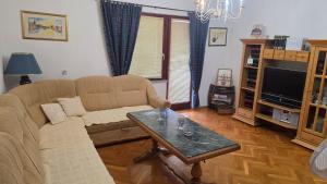 a living room with a couch and a coffee table at Apartmani Rama - terra nostra in Prozor