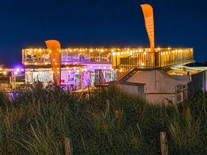 a building with lights on top of it at night at Modern Studio with Sea View and Balcony in Middelkerke