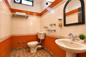 a bathroom with a toilet and a sink at Hotel Arina in Chandīgarh