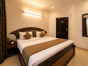 a bedroom with a large bed in a room at Hotel Arina in Chandīgarh